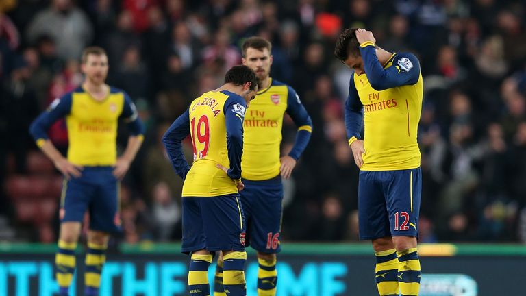 Olivier Giroud (R) and Santi Cazorla of Arsenal look dejected after conceding a third goal against Stoke City at the Britannia Stadium