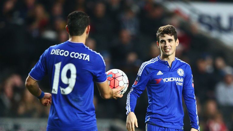Oscar of Chelsea celebrates scoring his hat-trick goal against MK Dons with team-mate Diego Costa 