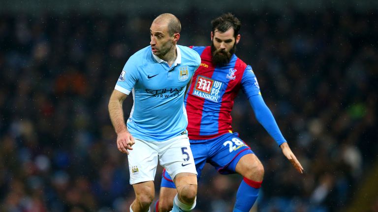 Pablo Zabaleta of Manchester City runs with the ball under pressure from Joe Ledley of Crystal Palace