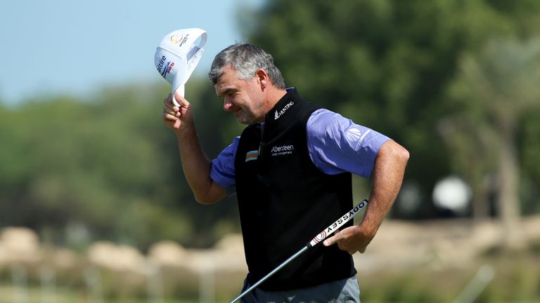 Paul Lawrie of Scotland doffs his cap on the 9th green during the second round of the Commercial Bank Qatar Masters