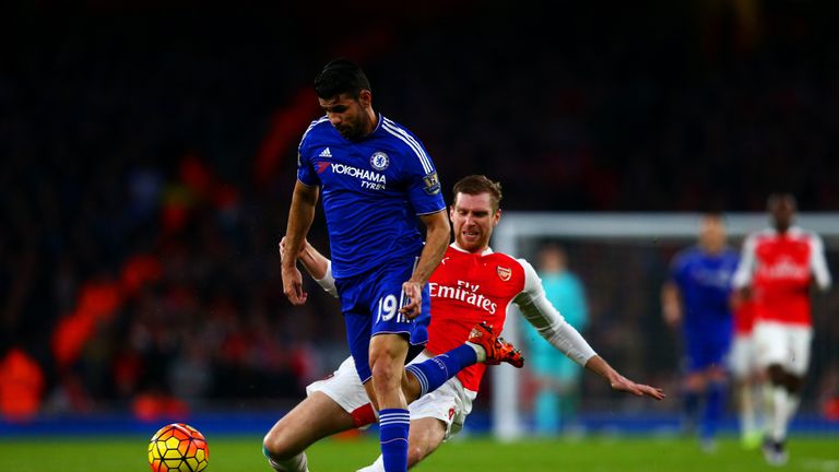 Arsenal's Per Mertesacker fouls Chelsea's Diego Costa and subsequently receives a red card