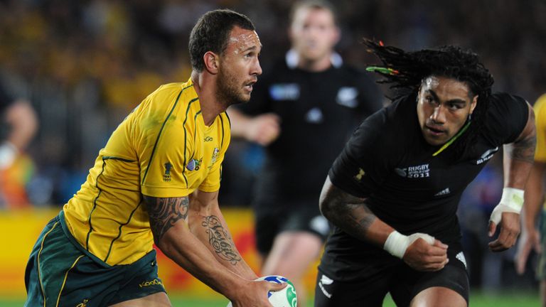 Australian Wallabies fly-half Quade Cooper (L) drop kicks towards goal in front of New Zealand All Black center Ma'a Nonu during the 2011 Rugby World Cup