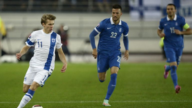 Finland's Riku Riski (L) and Greece's midfielder Andreas Samaris vie for the ball during the Euro 2016 Group F qualifying football match Finland vs Greece 