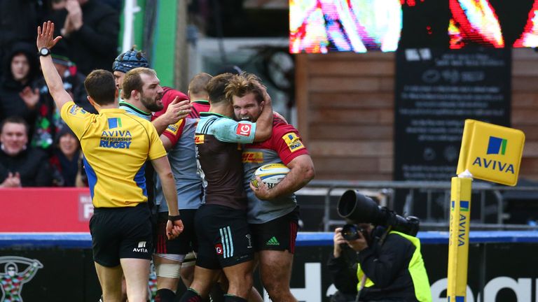 Rob Buchanan of Harlequins (right, with ball) celebrates scoring a try during the Aviva Premiership match with Saracens