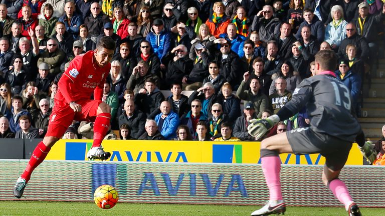 Roberto Firmino (left) scores Liverpool's first goal past Norwich City goalkeeper Declan Rudd to put the Reds 1-0 up