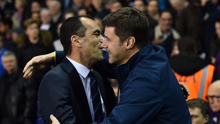 Tottenham Hotspur's Argentinian Head Coach Mauricio Pochettino (R) greets Everton's Spanish manager Roberto Martinez ahead of the English Premier League fo