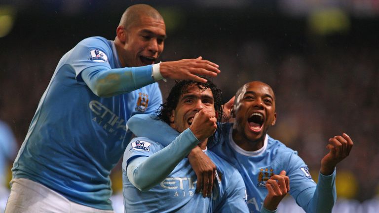 MANCHESTER, ENGLAND - DECEMBER 05:  Carlos Tevez of Manchester City celebrates scoring his team's second goal with team mates Robinho (R) and Nigel de Jong