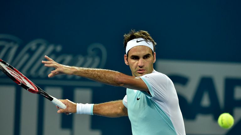 Roger Federer of Switzerland hits a return against Tobias Kamke