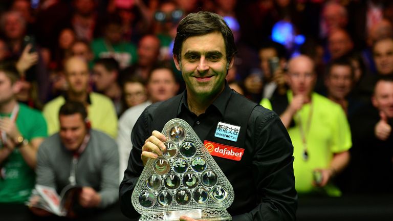 Ronnie O'Sullivan of England poses with the Masters Trophy after defeating Barry Hawkins 10-1 in the final