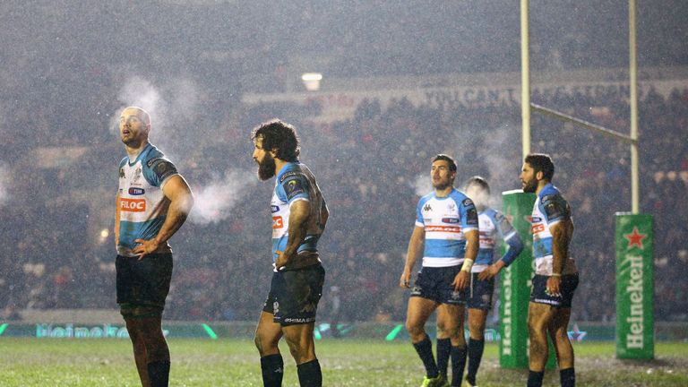 The players of Benetton Treviso look on as the snow falls during their heavy Champions Cup defeat at Leicester Tigers