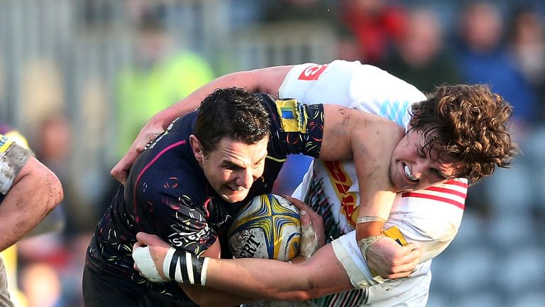 Tryscorer Phil Dowson (left) is tackled by Charlie Matthews