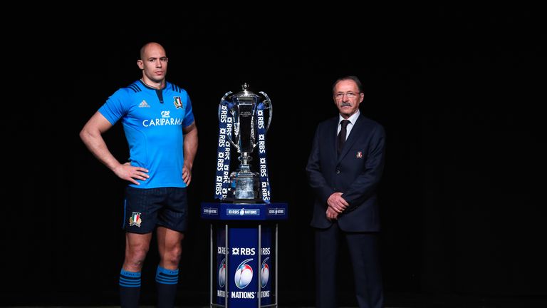 Italy captain Sergio Parisse and head coach Jacques Brunel pose with the Six Nations trophy