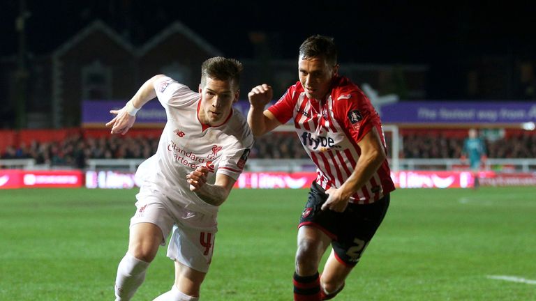 Liverpool's Ryan Kent (left) and Exeter City's Jordan Tillson battle for the ball during the Emirates FA Cup, third round match at St James Park, Exeter.