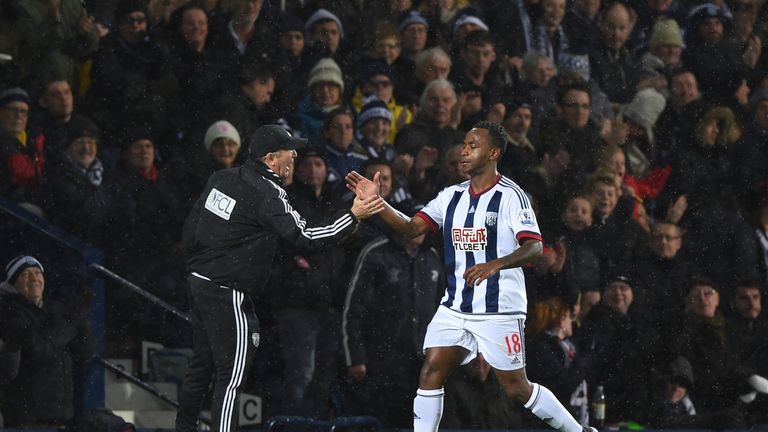 Saido Berahino of West Bromwich Albion shakes hands with manager Tony Pulis after scoring his team's first goal against Bristol City