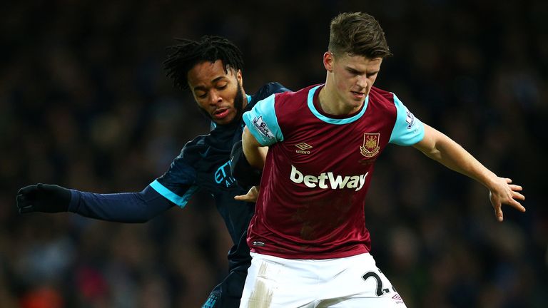 LONDON, ENGLAND - JANUARY 23:  Sam Byram of West Ham United holds off Raheem Sterling of Manchester City during the Barclays Premier League match between W