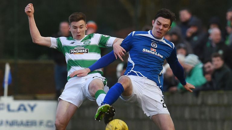 Kieran Tierney battles for the ball with Mark McGuigan 