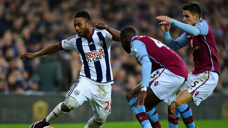 West Brom's Stephane Sessegnon (left) comes up against Ashley Westwood (right) and Aly Cissokho (centre) 