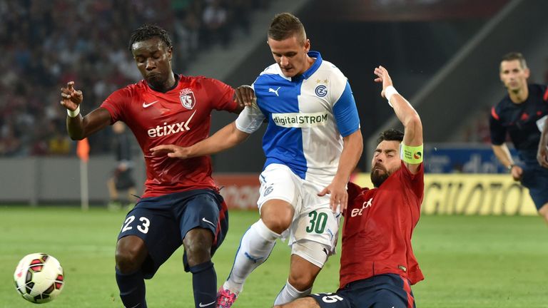 Grasshoppers Zurich's forward Shani Tarashaj (C) is tackled by Lille's Montenegran defender Marko Basa (R) and Senegalese defender Pape Souare (L)