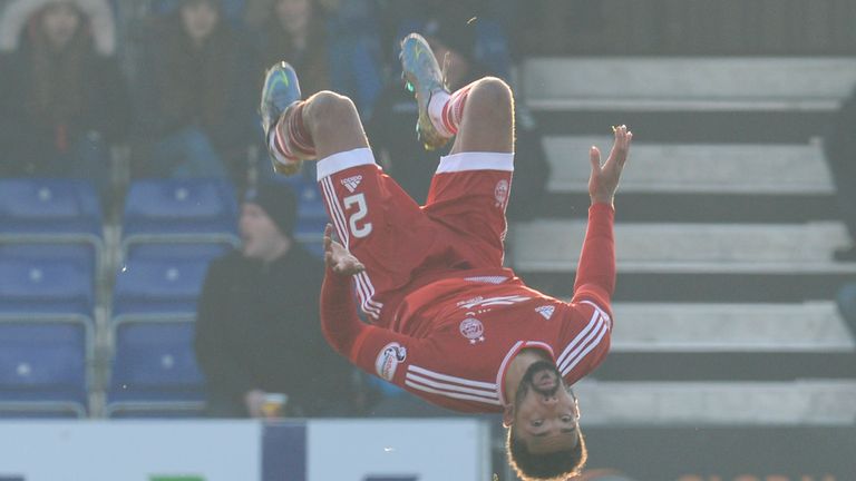 Aberdeen's Shay Logan celebrates after making it 3-1 against Ross County