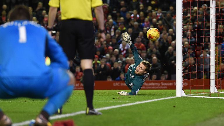Simon Mignolet of Liverpool saves a penalty during the Capital One Cup semi-final second leg v Stoke City at Anfield