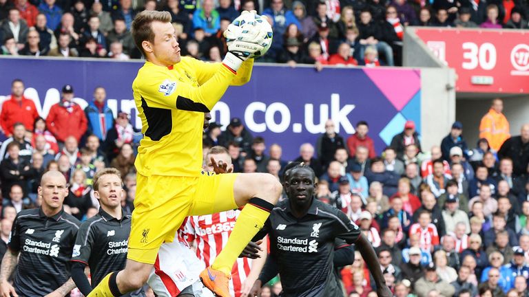 Liverpool goalkeeper Simon Mignolet catches the ball in a match against Stoke