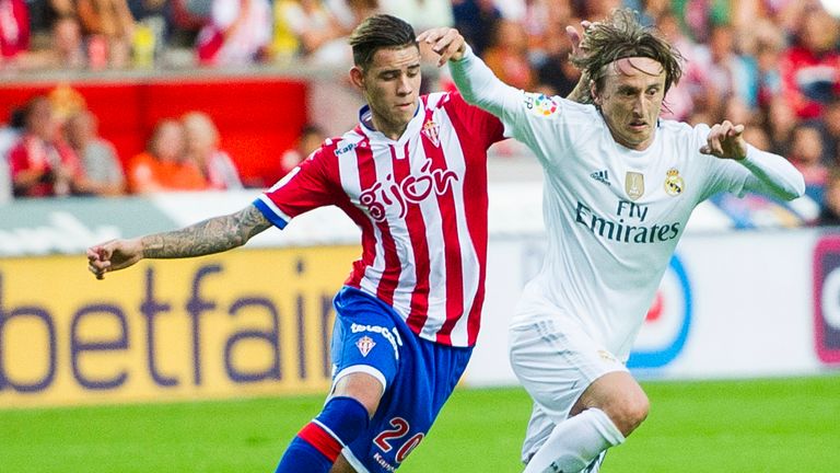 Luka Modric of Real Madrid duels for the ball with Arnaldo Sanabria of Sporting Gijon