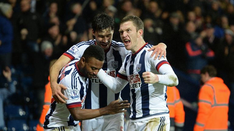 Stephane Sessegnon (L) of West Bromwich Albion celebrates scoring his team's first goal with his team mates Claudio Yacob and Craig Gardner (R)