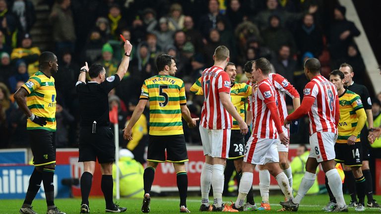 Referee Neil Swarbrick shows Norwich City's Gary O'Neil (fifth left) a red card