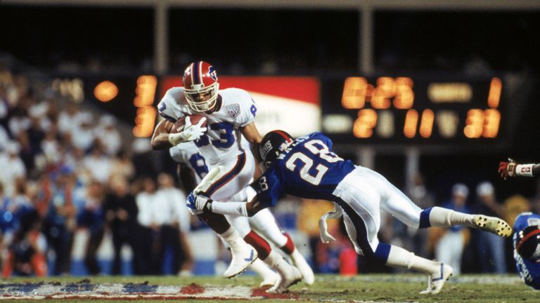 Andre Reed #83 of the Buffalo Bills tries to break away from a tackle by cornerback Everson Walls #28 of the New Yor