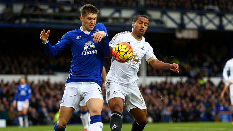 John Stones of Everton battles for the ball with Swansea' Wayne Routledge