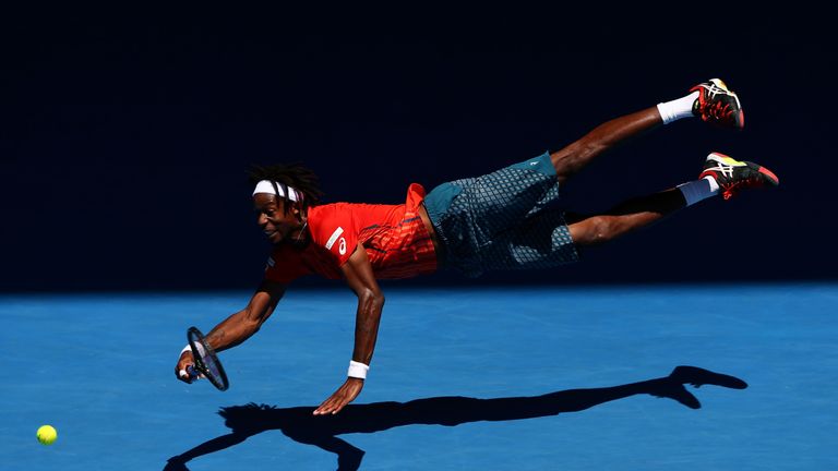 Gael Monfils dives for a forehand in his match against Andrey Kuznestov