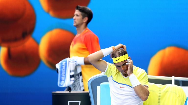 Fernando Verdasco walks behind Rafael Nadal at the Australian Open