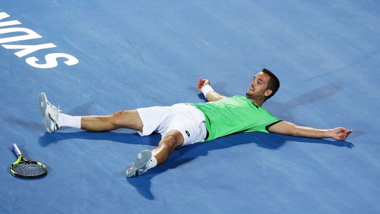 Viktor Troicki celebrates winning championship point in his men's final match against Grigor Dimitrov