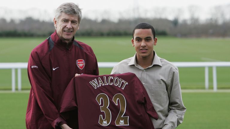 Theo Walcott poses with Arsene Wenger at his Arsenal unveiling in 2006