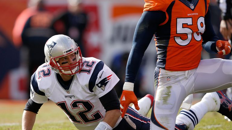 Tom Brady #12 of the New England Patriots looks on after a pass in the first half against the Denver Broncos