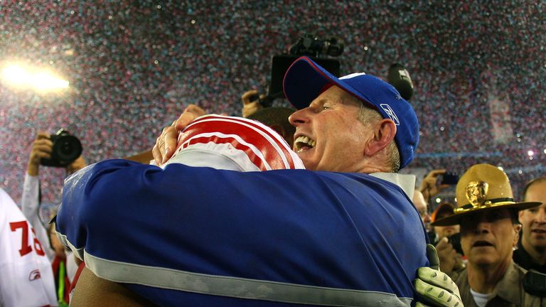 GLENDALE, AZ - FEBRUARY 03: Head coach Tom Coughlin of the New York Giants hugs Osi Umenyiora #72 after the Giants defeated the New England Patriots 17-14 