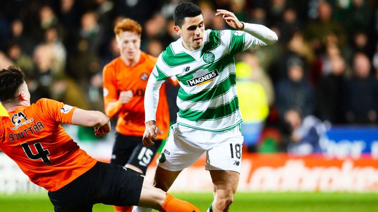John Souttar of Dundee United slides in to challenge Celtic's Tom Rogic during the Tannadice match