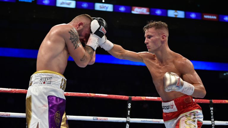 Tommy Martin (R) throws a right hand punch on Michael Devine in their bout for the vacant WBA continental super- lightweight crown