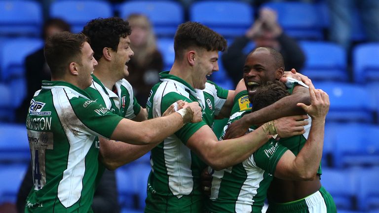 READING, ENGLAND - JANUARY 10: Topsy Ojo of London Irish (R) celebrates with team mates after scoring the teams second try of the game during the Aviva Pre