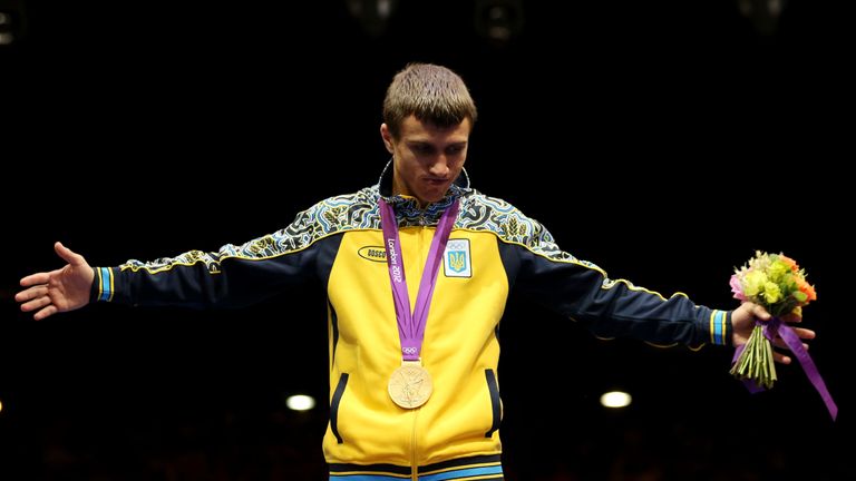 Gold medalist Vasyl Lomachenko of Ukraine celebrates on the podium during the medal ceremony for the Men's Light (60kg), London 2012