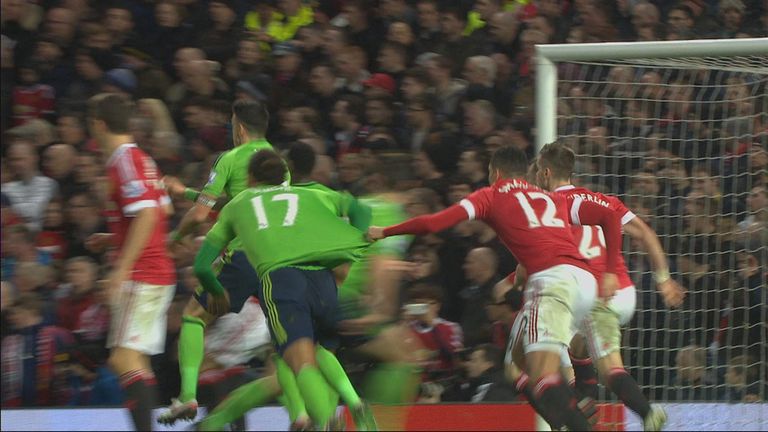 Virgil van Dijk has his shirt pulled by Chris Smalling