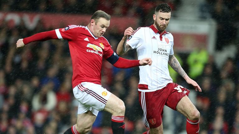 Wayne Rooney of Manchester United in action with David Edgar of Sheffield United 