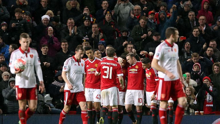 Sheffield United players stand dejected as Manchester United's Wayne Rooney (third right) celebrates scoring their first goal of the game