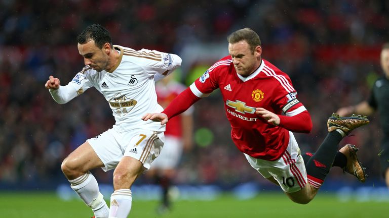 Wayne Rooney trips while competing for the ball with Swansea's Leon Britton
