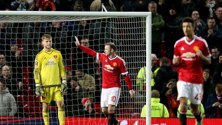 Sheffield United goalkeeper George Long (left) stands dejected as Manchester United's Wayne Rooney (centre) celebrates scoring their first goal of the game