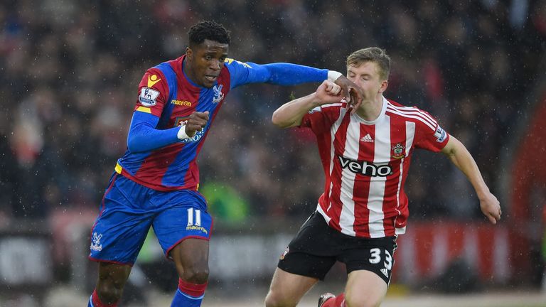 SOUTHAMPTON, ENGLAND - JANUARY 09:  Wilfried Zaha of Crystal Palace and Matt Targett of Southampton compete for the ball during the Emirates FA Cup Third R