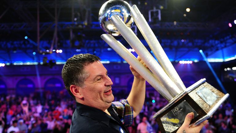 Gary Anderson of Scotland celebrates with the Sid Waddell Trophy after defeating Adrian Lewis of England
