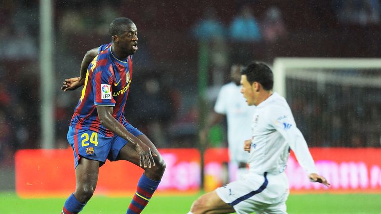 BARCELONA, SPAIN - MAY 04: Toure Yaya of Barcelona puts the ball past a Tenerife player during the La Liga match between Barcelona and Tenerife at Camp Nou