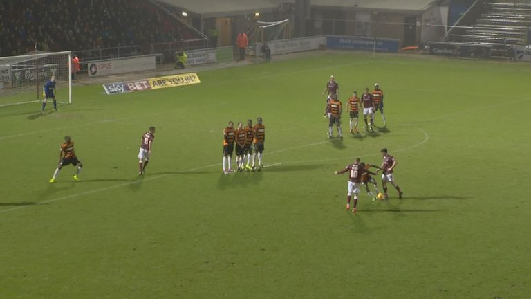 Yiadom (Barnet) believes Northampton's Gavin Hoyte has touched the ball from a free-kick, therefore runs out of the wall and kicks the ball away.