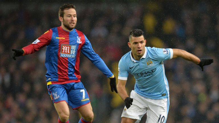 Manchester City striker Sergio Aguero (R) runs with the ball from Crystal Palace's Yohan Cabaye